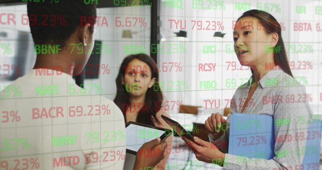 Image of stock market over diverse business people talking in office. Global business and digital interface concept digitally generated image.