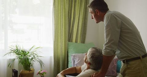Senior Woman in Wheelchair Consulting Doctor at Retirement Home