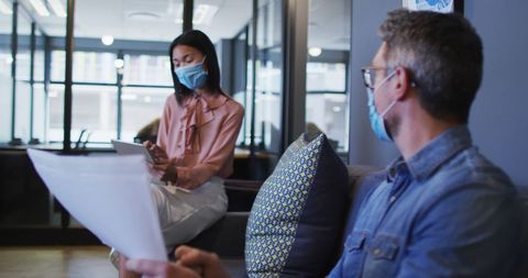 Colleagues Wearing Face Masks Discussing in Modern Office