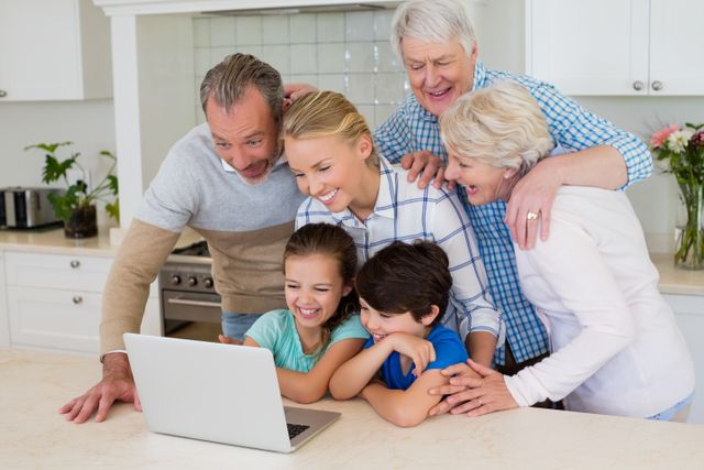 Happy Multigenerational Family Using Laptop in Kitchen - Download Free Stock Photos Pikwizard.com