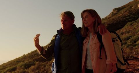 Senior Couple Embracing During Sunrise Nature Hike
