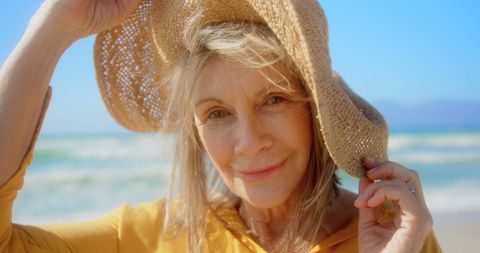 Smiling Senior Woman in Sun Hat at Beach on Sunny Day - Download Free Stock Images Pikwizard.com