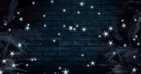 Snowy Fir Trees Against Brick Wall for Festive Atmosphere - Download Free Stock Images Pikwizard.com
