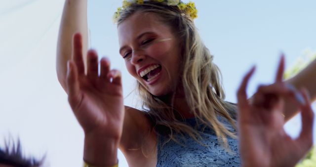 Joyful Young Woman Dancing Outdoors with Flower Crown - Download Free Stock Images Pikwizard.com