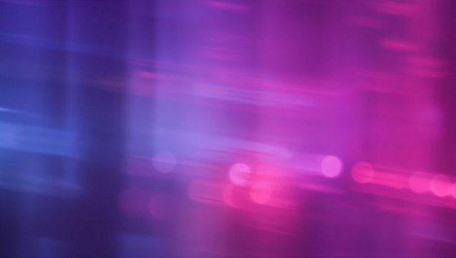 Abstract Blur of Violet and Pink Neon Streaks on Digital Canvas