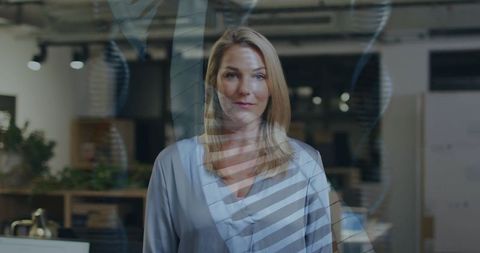 Businesswoman with dna overlay technology interface in modern office