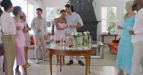 Engagement celebration with friends and champagne in elegant room