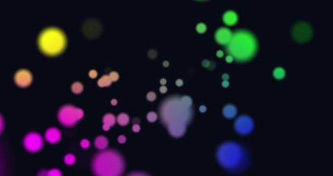 Vibrant Glowing Dots in Motion on Black Background