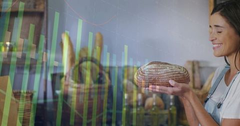 Bakery owner holding artisanal sourdough loaf with chart overlay showing business growth