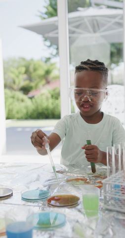 Young Boy Conducting Chemistry Experiments at Home with Test Tubes