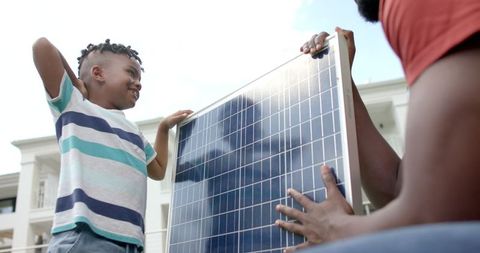 Father and Son Exploring Solar Energy Solutions Together - Download Free Stock Images Pikwizard.com