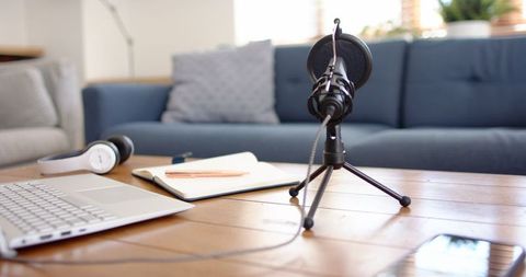 Home podcast studio with microphone and laptop setup