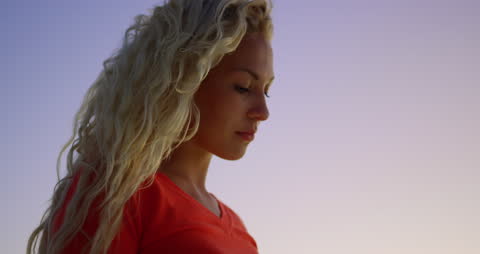 Serene Woman Texting on Beach at Dusk