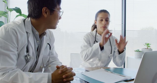 Two Medical Professionals Discussing Patient Case in Modern Office - Download Free Stock Images Pikwizard.com