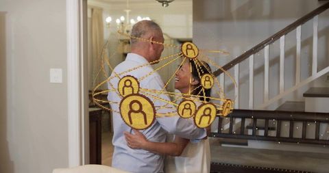 Asian couple hugging at home with golden ar network overlay, intimate embrace
