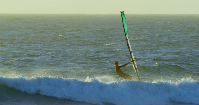 Windsurfer Gliding over Ocean Waves at Sunset - Download Free Stock Images Pikwizard.com