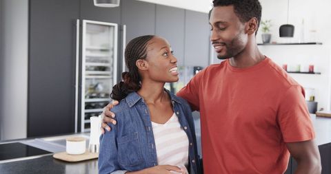 Happy Couple Embracing in Modern Kitchen Environment - Download Free Stock Images Pikwizard.com