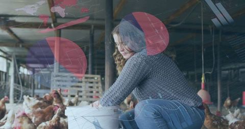 Farm caretaker feeding chickens in sustainable poultry barn