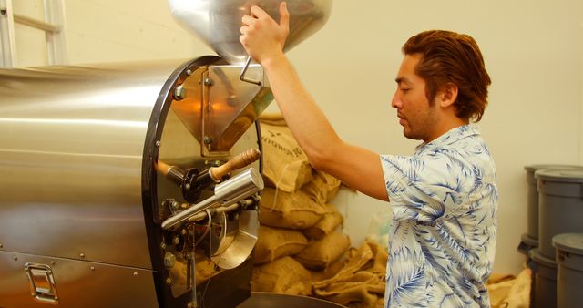 Man Operating Coffee Roasting Machine in Workshop - Download Free Stock Images Pikwizard.com