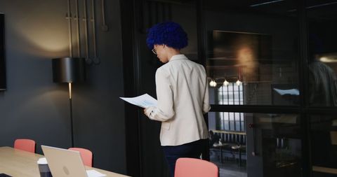 Professional businesswoman analyzing documents in modern office