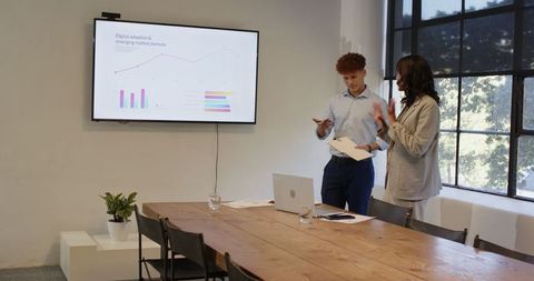 Diverse professionals analyzing digital trends in modern conference room