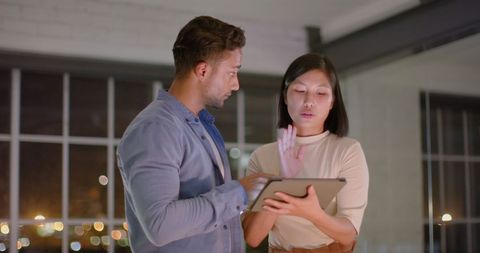 Diverse Colleagues Discussing Project on Tablet in Modern Office