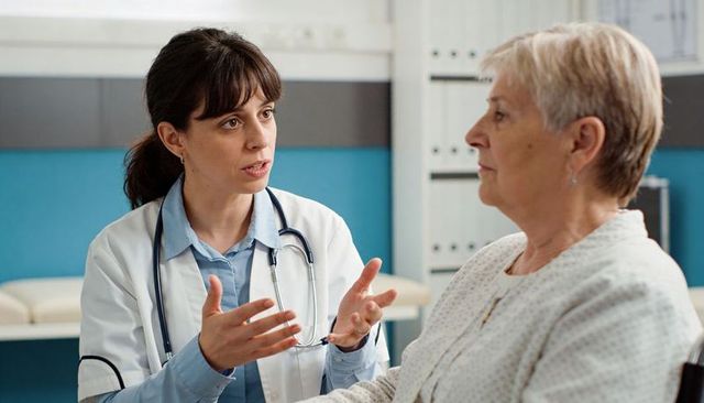 Doctor explaining care plan to senior patient during clinic consultation
