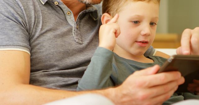 Father and Son Using Tablet Together at Home - Download Free Stock Images Pikwizard.com