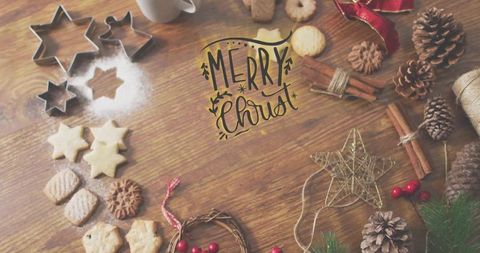 Rustic christmas cookie baking with star cutters and hand-lettered greeting on wooden tabletop