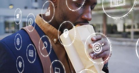 Urban commuter eating sandwich while navigating virtual business analytics interface overlay