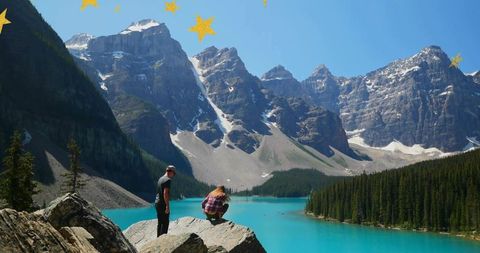 Couple overlooking scenic lake with majestic mountains