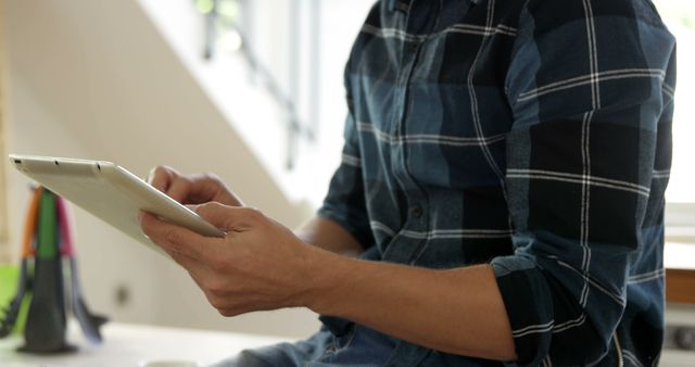 Man in Plaid Shirt Using Digital Tablet in Bright Room - Download Free Stock Images Pikwizard.com