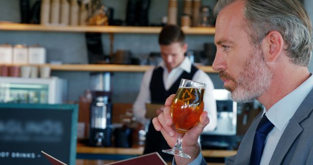 Businessman in a Suit Enjoying Refreshing Drink at Trendy Cafe - Download Free Stock Images Pikwizard.com