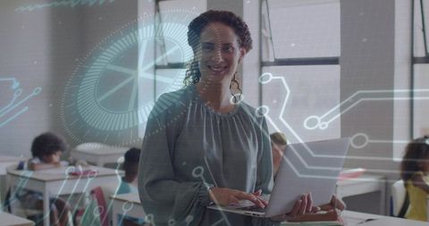 Teacher presenting digital lesson with laptop and futuristic HUD overlay in classroom