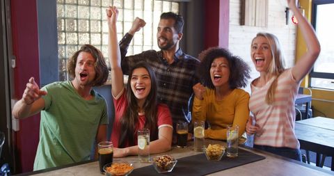 Joyful Group of Friends Celebrating During Sports Match