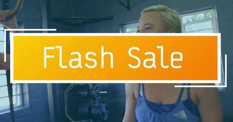 Female athlete training in gym with bold flash sale banner and gymnastic rings