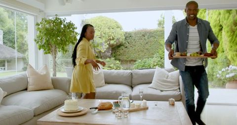 Couple Preparing for Celebration in Bright Living Room