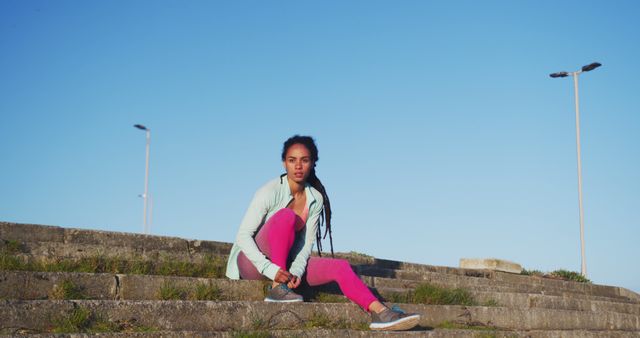 Young Woman Preparing for Workout Outdoors on Stairs - Download Free Stock Images Pikwizard.com