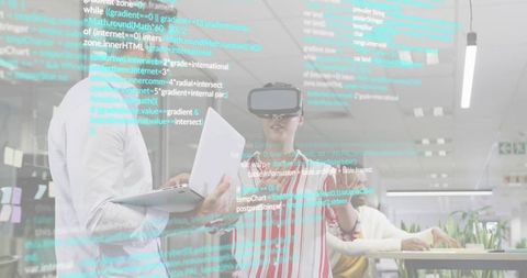Woman testing vr headset in open office with projected code for tech collaboration and laptop demo