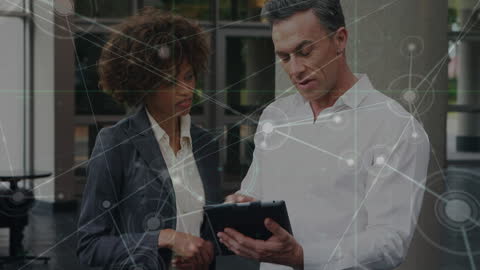 Professionals Collaborating on Digital Tablet in Modern Workplace