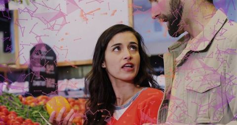 Couple Discussing Fresh Produce in Vibrant Market