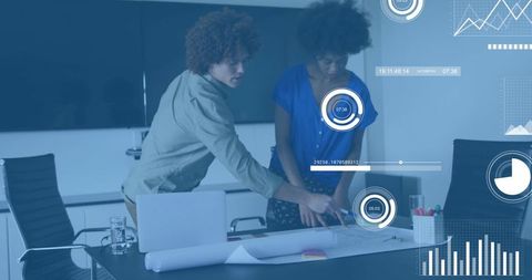 Collaborating over blueprint with digital dashboards and overlays in office