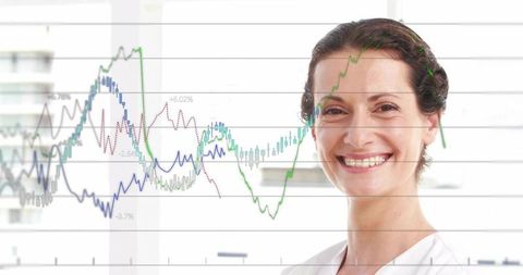 Smiling professional woman displaying financial charts and analytics overlay in office