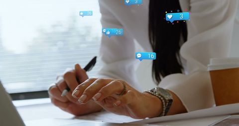 Businesswoman Engaging with Digital Social Media Icons While Working