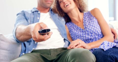 Happy Couple Enjoying TV Time on Cozy Couch