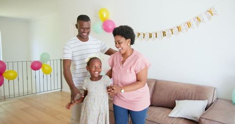 Family Celebrating Birthday with Joy and Decorations at Home