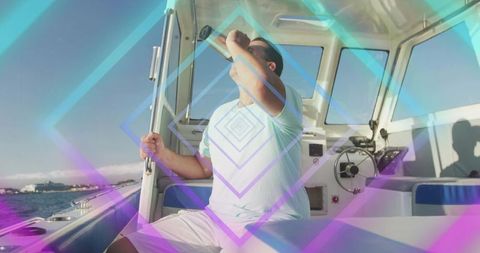 Man scanning horizon from motorboat cockpit gripping rail and shielding eyes with binoculars