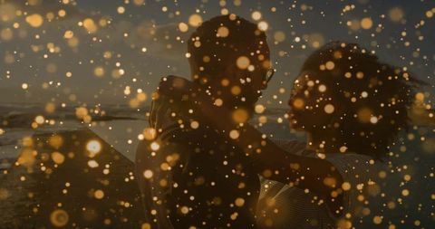 Golden bokeh romance: embracing couple leaning close at sunset beach
