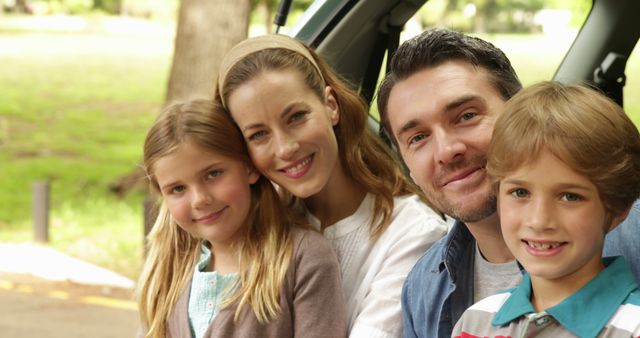 Happy Family Sitting in Car Trunk During Outdoor Picnic - Download Free Stock Images Pikwizard.com