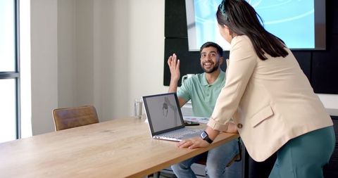 Colleagues discussing robotic design project in modern office